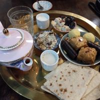Cardamom tea (oat milk on the side), baklava, halwa, pashmak, lavashak, pita, dates, vegan feta, assorted nuts at Charcoal and Chai in Como