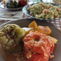 Gemista (stuffed peppers with tomatoes, rice, and herbs) with a tabule salad to share. Big portions.   at Palia Plaka - Παλιά Πλάκα in Kefalonia