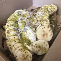 Peanut butter, banana, sourdough, coconut yoghurt, pistachio  at Box & Barber Coffeehouse in Newquay