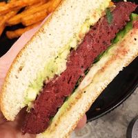 Beetroot quinoa burger: smashed avocado, lettuce, homemade vegan mayo, served with sweet potato fries  at Jam Limassol in Limassol