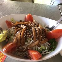 Salad with chikin strips on top and ginger dressing  at VeggiEAT - Summerlin in Las Vegas