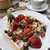 Vegan Waffle with vegan vanilla ice, vegan chocolate spread/sauce and strawberries.  at Kleines Waffelhaus in Luebeck