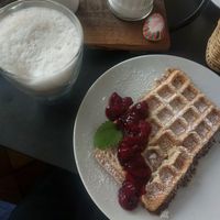 Vegan waffles with cherries and latte macchiato with oat milk at Kleines Waffelhaus in Luebeck