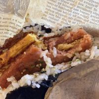 Omni pork surrounding just egg, wrapped with rice, herbs and nori  at Wellness Sushi in Denver