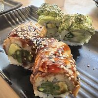 Foreground: vegan “eel” (eggplant) roll. Background: unknown delicious roll.  at Wellness Sushi in Denver