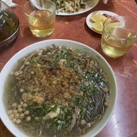Faux meat chunks in vegetable broth with glass noodles, dumplings and cilantro. The other meal is friend pho noodles with faux shrimps and tofu.   at Bo De Tam in Prague