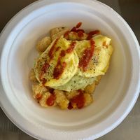 Vegan egg, tots, avocado spread, green chili & sriracha  at Buddha's Brew in Mesa