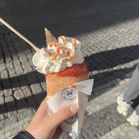 Strawberry jam chimney stuffed with bananas and whipped topping 🍌 🍓 🤍  at Sweet Dreams in Prague