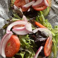 Open faced bagel sandwich : everything bagel topped with homemade red pepper hummus, spring mix, cucumber, tomato & onion.   at The Exchange in Colorado Springs