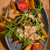Loaded fries with mushrooms and truffle mayo at Hans Im Glück - Mercedes Platz in Berlin