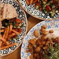 Pita’s with falafel and sweet potato fries. Optional salad mixture (this one is tomato&paprika salad)  at Mazel Tov in Budapest