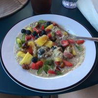 Overnight oats with almond butter, dates, and fresh fruit at Shy Bird in Cambridge