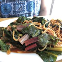 Tempeh with chard and ginger rum bbq sauce served with lo mein at Bela in Northampton