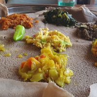 Bed of Teff ingera (gluten free extra easy to digest),  Lentils cooked in three different spices, spinach, and also Aliccia, don't recall the dish in the middle. Delicious  at Addis Kitchen in South East London