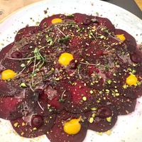 Beetroot carpaccio with pistachio and mango salsa ( vegan ) at Aromatic Restaurant in Altafulla
