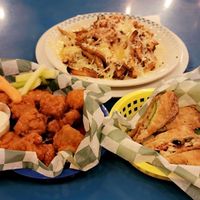 Tiger wings, dico fries, & avocado rolls. at The Green Pig Pub in Salt Lake City