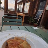 Raviolis artesanos con bechamel y espinacas, con salsa de tomate casera y levadura nutricional at Brio in Tarifa