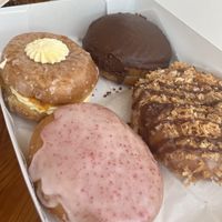 Peaches and cream, Boston cream, Samoa and almond chewy. All so good.   at Joyfully Baked in Gainesville