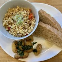 Brunch plate composed of Roasted potatoes with pesto, focaccia with garlicky mashed cauliflower and ebly tomato & chesnut salad. #Veganuary at Carli's Coffee in Echternach