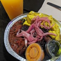 Custom bowl - coconut rice, garlic/lime beans, sofritas, plantains, curried tofu, pickled onions, peanut sauce & chimichurri with mango/grapefruit juice 👌🏼 at The Floribbean in St Petersburg