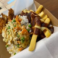 Fries with Gravy Topped with Curry Rice and Some Mozzarella Sticks.  at KD's Vegan Takeaway in Townsville
