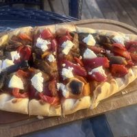 Vegan pide pizza with vegetables and crumbled tofu  at Harissa in Almaty