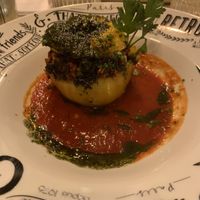 Stuffed pepper with mixed cereals and beans, on top of tomato sauce. Topped with pesto   at Au Vieux Gassin in Gassin