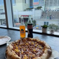 Hawaiian pizza w/sodas and seated inside the restaurant (huge window on one side)  at Down 2 Earth Plant Based Cuisine in Las Vegas