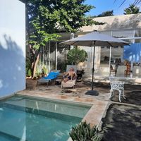 Chill out by the pool with apartment behind at Casa Kaan in Merida