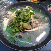 Saviry udon noodle soup with fresh herbs, tofu and saitan at Com Chay in Mannheim