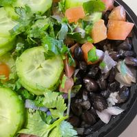 Vegan Bowl: White Rice (or you could get Romaine), Seasoned Black Beans & Onions, topped with Cucumbers, Tomatoes, Avocados* Lime wedge**, and Cilantro. at Coco Loco in Denver