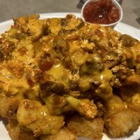 Breakfast burrito filling over tator tots  at The Bayside Cafe in Everett