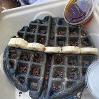 Charcoal waffle with blueberries, coconut whipped cream, maple syrup, cacao nibs at BOL in Wellfleet