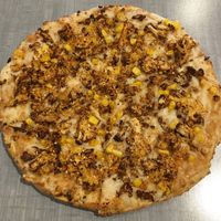 Vegan Kerala Coconut Pizza (coconut curry, sweet corn, ‘gunpowder’ & scallions). Non-traditional ingredients with bold flavors. at Bombay Pizza Kitchen in Plymouth