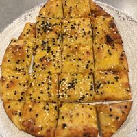 Garlic Naan Bites (veganize by asking for a vegan dip). Nice appetizer size. Kind of like a flat pretzel. at Bombay Pizza Kitchen in Plymouth