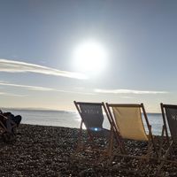 Kiosk deck chairs on beach at Kiosk in Lyme Regis