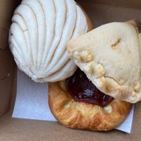 Vanilla concha, empanada, and guava danish at the bottom at Toluca Bakery and Cafe in Los Angeles