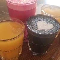 Fruit juice, "black metal" (coffee latte) and "bloody" beetroot latte at Lucifer Lives in Brussels