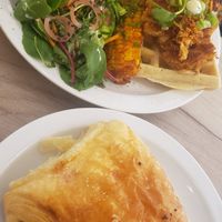 Chicken waffles, corn, cinnamon tomato beans and pain au chocolat at Lucifer Lives in Brussels