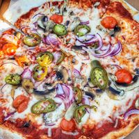 Pizza with custom toppings including vegan cheese at Captain pizza in Cowes