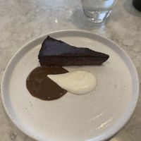 Chocolate torte. Have no idea what we’re the sauces but they were incredible especially the white one!! 🤩  at Holy Carrot in London