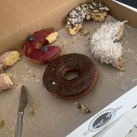 Half eaten donuts because we couldnt wait to chow down!!!  SO good!! Highly recommend the pistachio!   at Donut Villa Diner in Malden