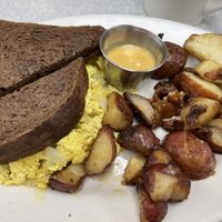 Tofu Scramble with breakfast potatoes, house creamy cheese and dark rye toast  at Donut Villa Diner in Malden