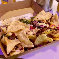 “Half” a Fully Loaded Nachos in a doggy bag to take home.   at Club Mexicana - Soho in London