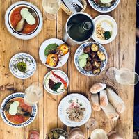 Hot aubergine, cauliflower, Petnat wine, caramelized sweet potato, Hummus, Labneh, Tahini and Spicy, fresh and warm bread, torn potatoes, Majadara,   at Cafe Pilz in Berlin