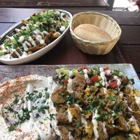Loaded pommes and shawarma on the plate with pita bread  at Dominion Food Revolution in Frankfurt
