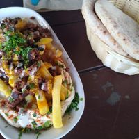 Loaded fries with minced meat and hummus at Dominion Food Revolution in Frankfurt