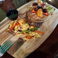 Pancakes de avena decorado con variedad de frutas y nueces. + add revoltillo de tofu at Madre Tierra in Caguas