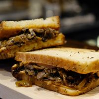 Vegan panini made with homemade sourdough bread. This one is caramelized onions and mushrooms, with homemade vegan sun dried tomato mayo. Soo good! at Café Mellemfolk in Aarhus