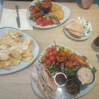 Down falafel salad, left nachos and vegan mozzarella on top, up vegan breakfast at Stiles in Ambleside